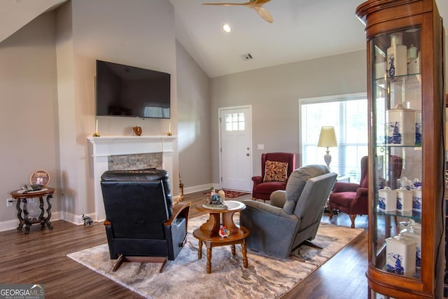 living room with hardwood / wood-style floors, high vaulted ceiling, and ceiling fan