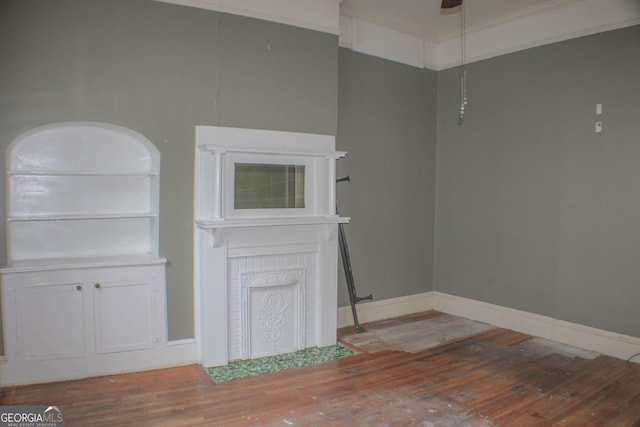 spare room featuring hardwood / wood-style flooring, crown molding, and ceiling fan