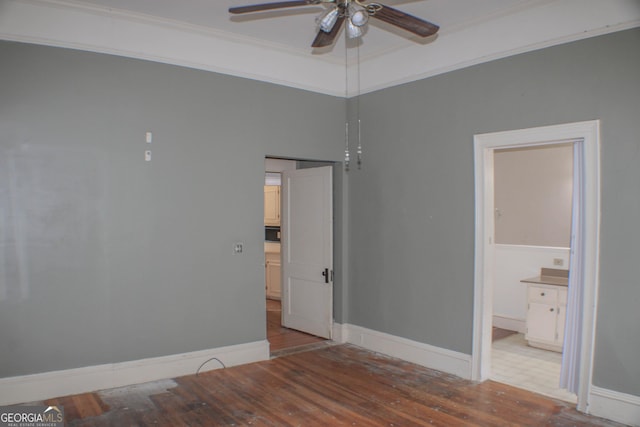 unfurnished bedroom featuring crown molding, ensuite bathroom, and light hardwood / wood-style flooring