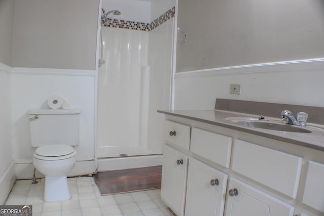 bathroom featuring vanity, toilet, and walk in shower