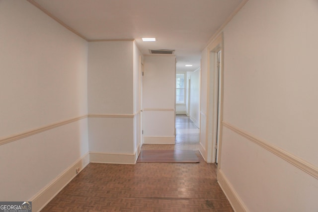 hall with crown molding and dark parquet flooring