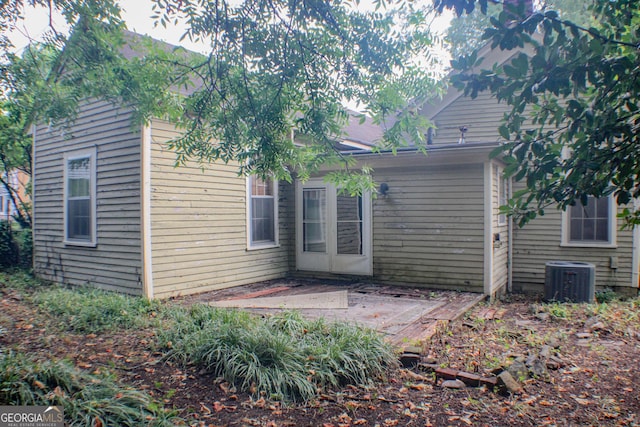 back of house with cooling unit and a patio