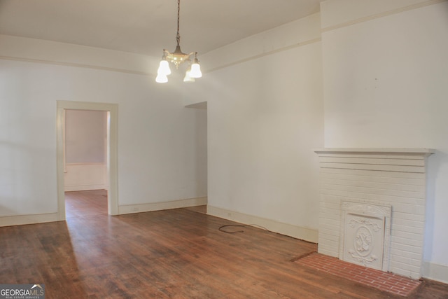 unfurnished dining area with dark hardwood / wood-style flooring and a notable chandelier