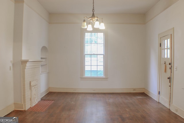 interior space featuring dark wood-type flooring and a chandelier