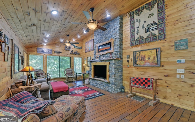 living room featuring wood walls, a fireplace, hardwood / wood-style floors, and wooden ceiling