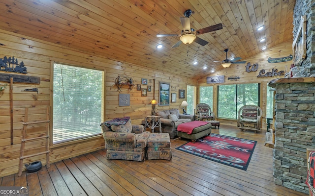 interior space featuring wood ceiling, wood-type flooring, high vaulted ceiling, wooden walls, and ceiling fan