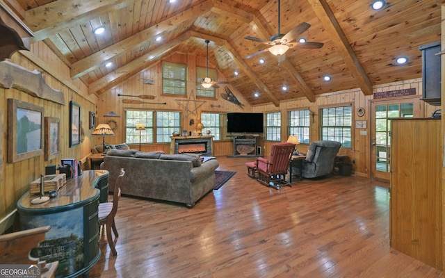 living room with hardwood / wood-style flooring, wooden walls, high vaulted ceiling, and wooden ceiling