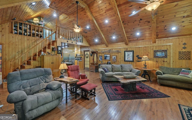 living room featuring wood ceiling, ceiling fan, wood-type flooring, and beamed ceiling