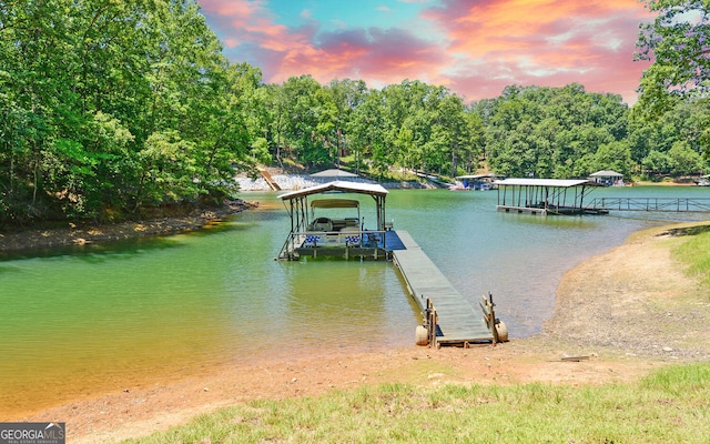 dock area featuring boat lift and a water view