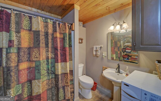full bath featuring baseboards, wooden ceiling, toilet, washer / clothes dryer, and a shower with shower curtain