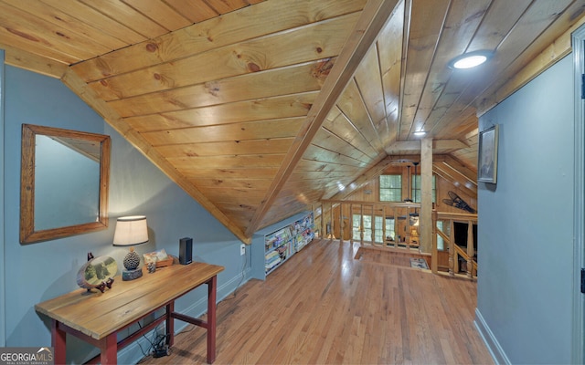 additional living space featuring wood ceiling, vaulted ceiling, baseboards, and hardwood / wood-style flooring