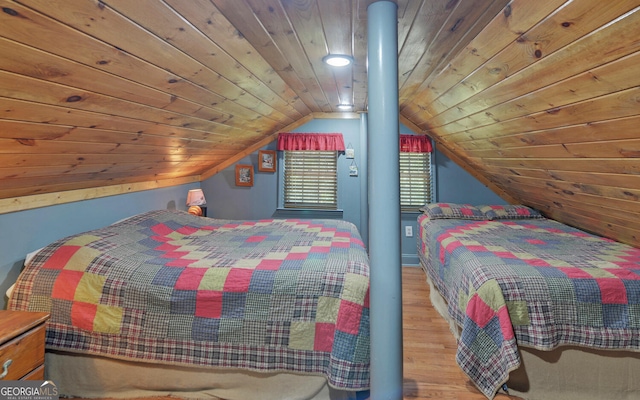 bedroom with vaulted ceiling, hardwood / wood-style floors, and wooden ceiling