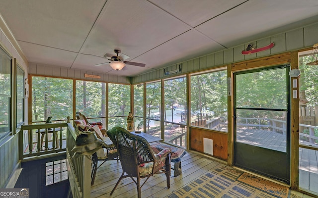 unfurnished sunroom featuring a wealth of natural light and ceiling fan