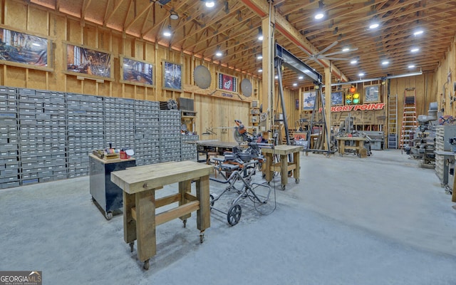 misc room with concrete flooring and a workshop area