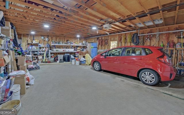 garage featuring a garage door opener and a workshop area