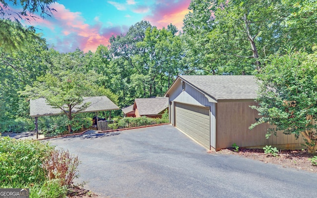 view of garage at dusk