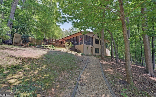 view of yard featuring a sunroom and a deck