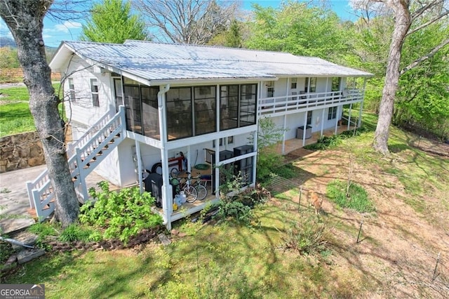 rear view of house with a sunroom