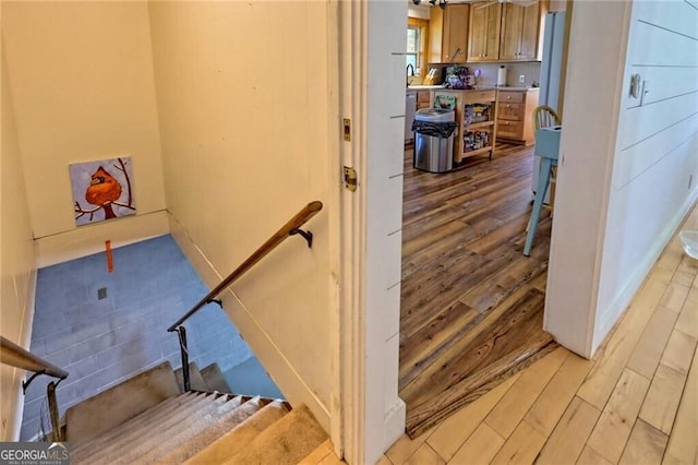 stairs featuring hardwood / wood-style flooring