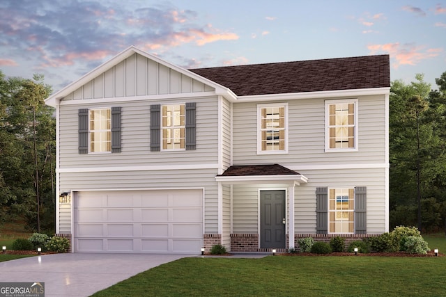 view of front of property featuring a garage and a yard