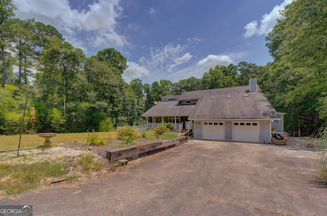 view of front of house featuring a porch and a garage