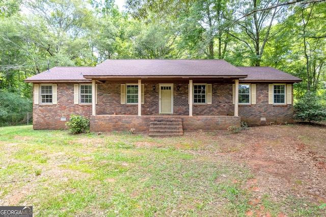 ranch-style home featuring a porch and a front lawn