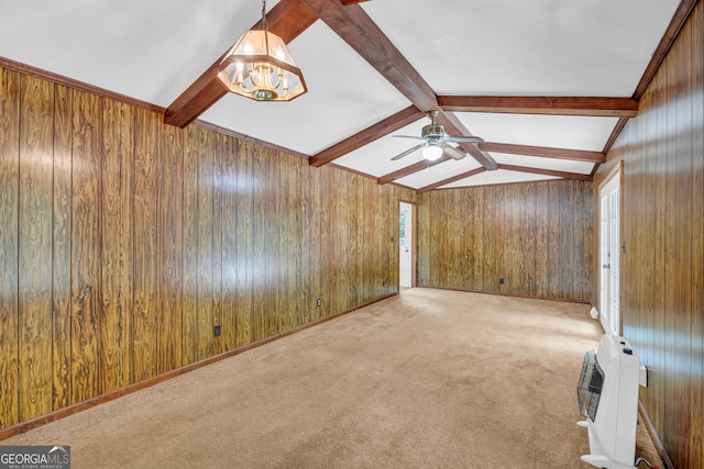 interior space with ceiling fan, lofted ceiling with beams, heating unit, wood walls, and light carpet