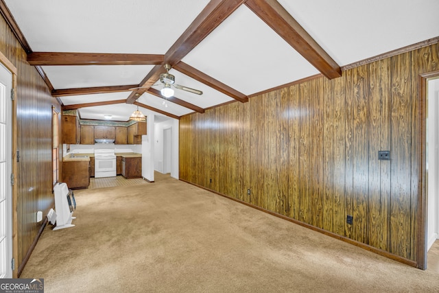 unfurnished living room with lofted ceiling with beams, light colored carpet, ceiling fan, and wooden walls