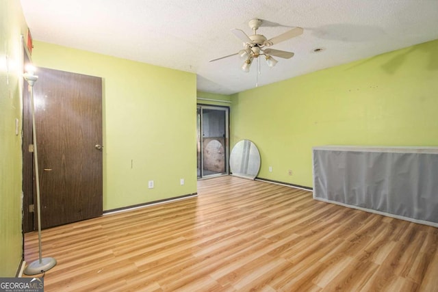 unfurnished bedroom featuring a textured ceiling, light hardwood / wood-style flooring, and ceiling fan