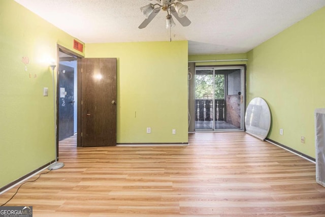 unfurnished room featuring light hardwood / wood-style floors, a textured ceiling, and ceiling fan