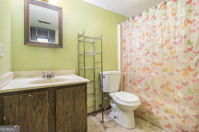 bathroom featuring a textured ceiling, toilet, and vanity