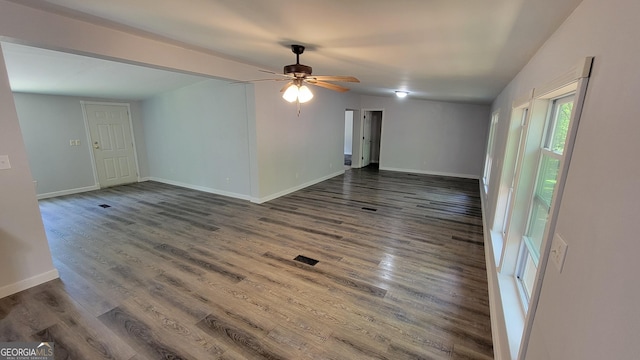 empty room featuring ceiling fan and dark hardwood / wood-style flooring