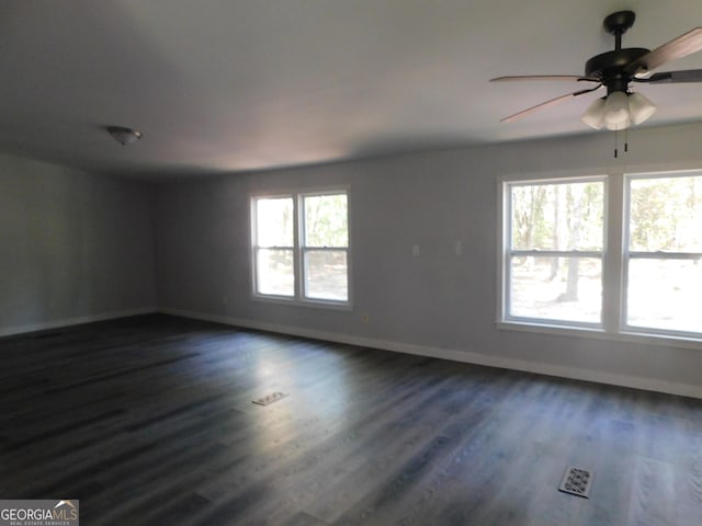 unfurnished room featuring dark wood-type flooring and ceiling fan