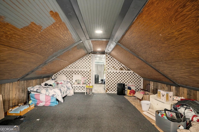 interior space with lofted ceiling and wooden walls