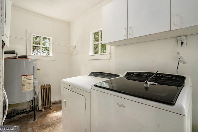 clothes washing area with cabinets, electric water heater, crown molding, washer and dryer, and radiator heating unit