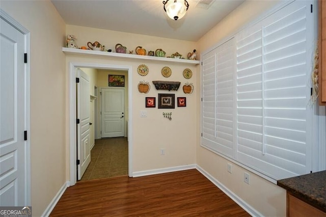 corridor featuring dark hardwood / wood-style flooring