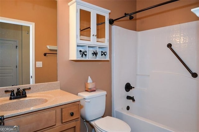 full bathroom featuring toilet, vanity, and washtub / shower combination