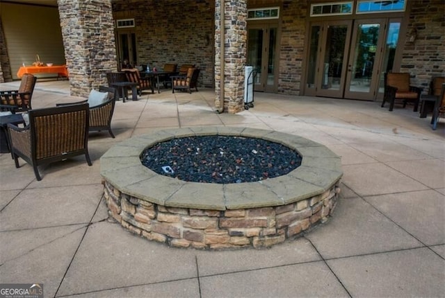 view of patio / terrace with french doors and a fire pit