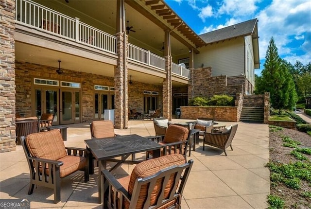 view of patio / terrace with an outdoor hangout area, ceiling fan, french doors, and a balcony