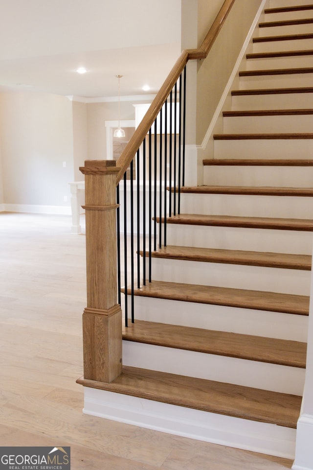 stairs featuring hardwood / wood-style floors