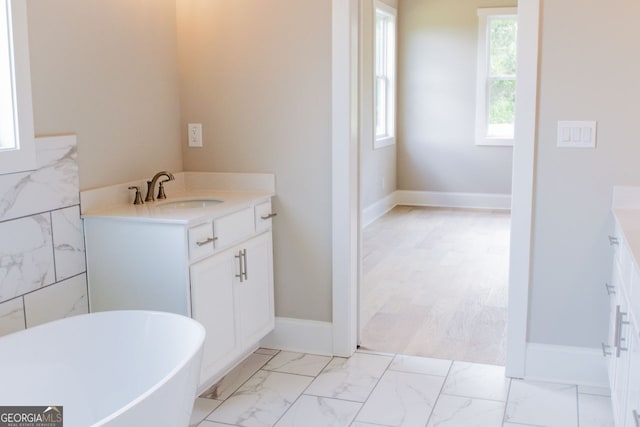 bathroom featuring vanity and a tub