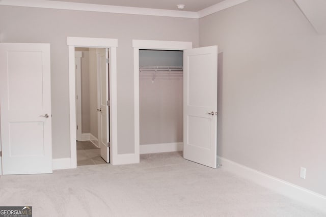 unfurnished bedroom featuring light colored carpet and a closet