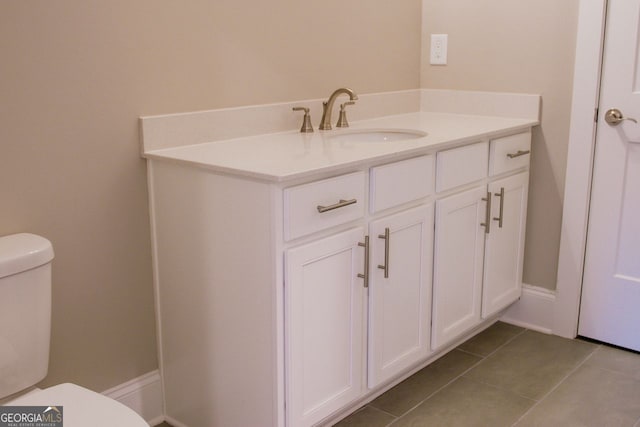 bathroom featuring tile patterned floors, vanity, and toilet