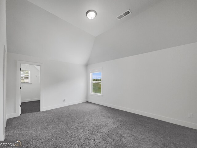 bonus room featuring carpet flooring and vaulted ceiling