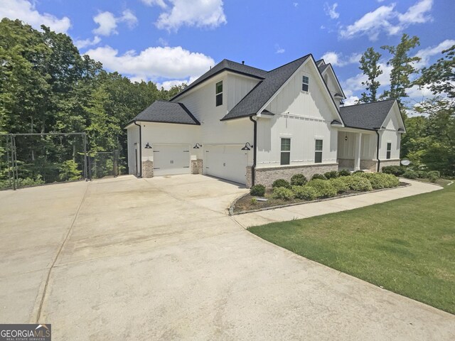 view of side of property featuring a garage and a yard