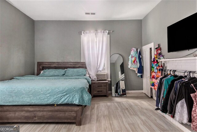 bedroom with light hardwood / wood-style floors