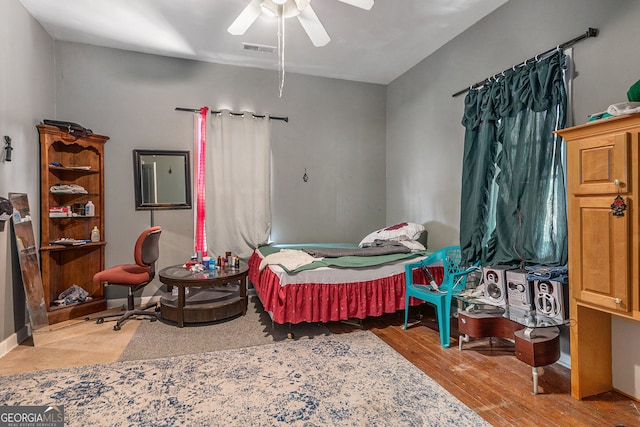 bedroom with ceiling fan and wood-type flooring