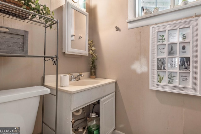 bathroom featuring vanity and toilet