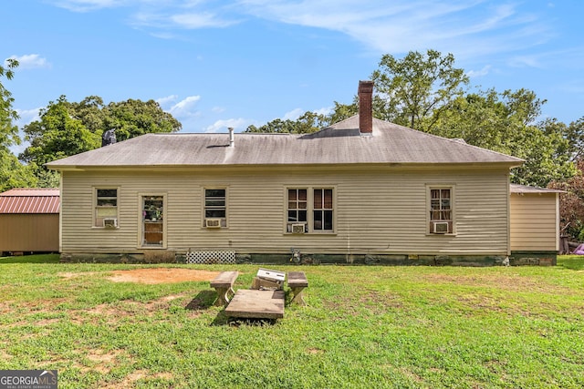 back of property with cooling unit and a lawn