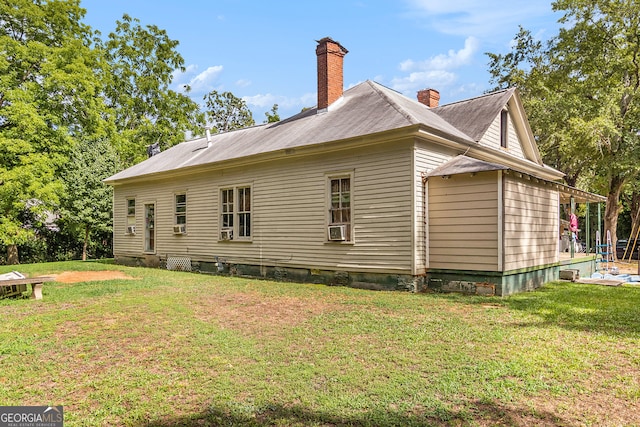 view of side of home with a yard